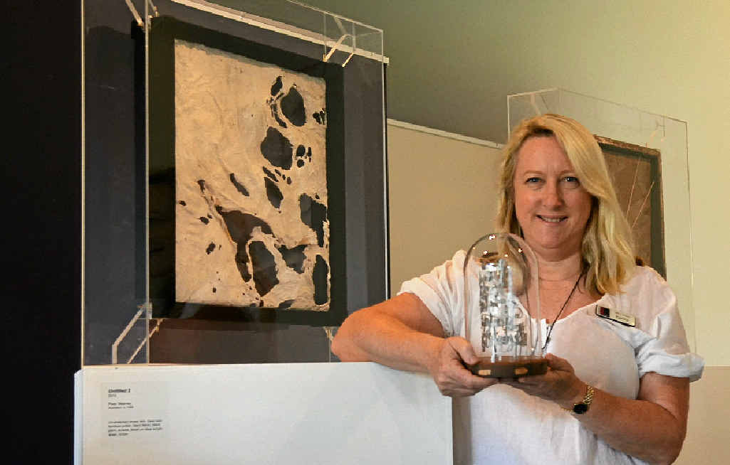 Warwick Art Gallery Director Karina Devine with her Gallery and Museum Achievement Award, created by artist Madeleine Brown, for her contribution to arts in regional Queensland, featuring Untitled 2 (2010) by Peta Warner.